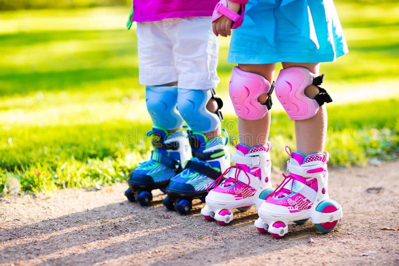 Kids roller skating in summer park