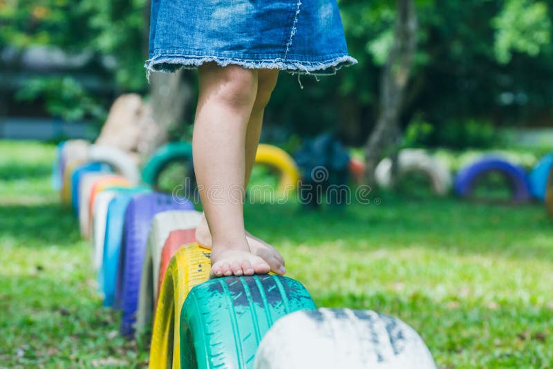 Kids Running on Tires in the Playground Stock Image Image of clouds