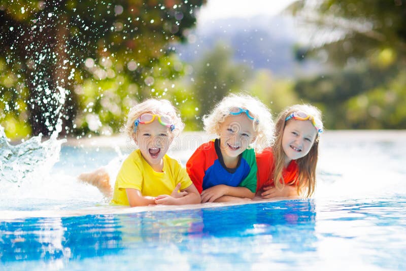 Kids in swimming pool. Children swim. Family fun