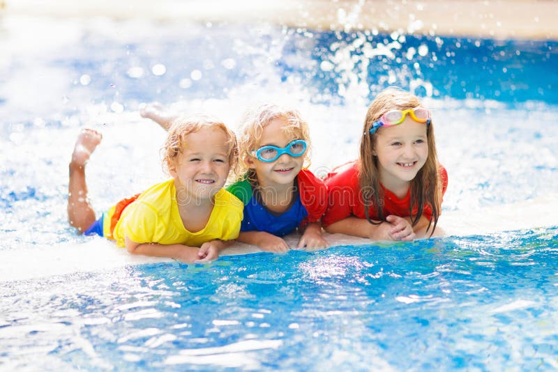 Kids in swimming pool. Children swim. Family fun