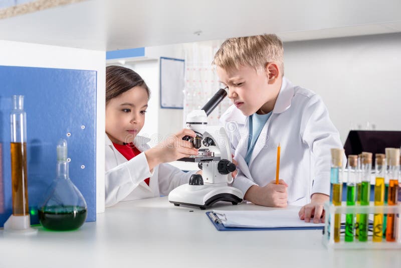 Kids using microscope stock photo. Image of girl, scientists - 90722670