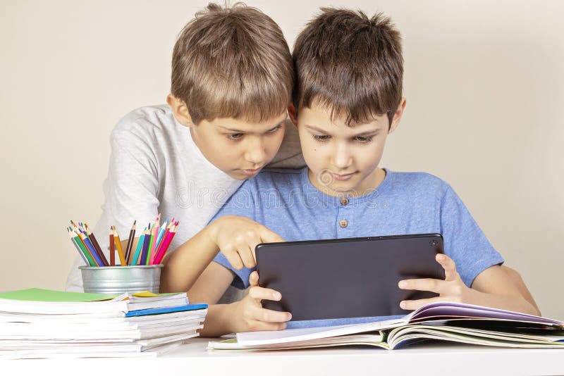 Kids using together tablet computer at home royalty free stock photography Kids using together tablet computer at home royalty free stock photography