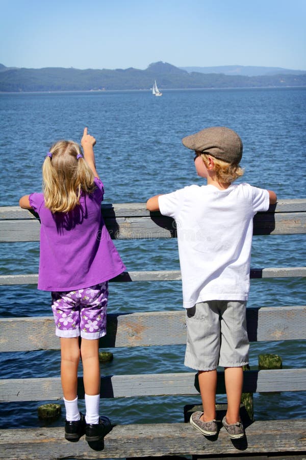 Kids watching a sailboat