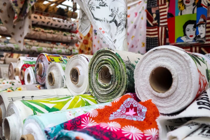 Kiel, Germany - 16. October 2022: Samples of cloth and fabrics with price signs in different colors found at a fabrics market. Kiel, Germany - 16. October 2022: Samples of cloth and fabrics with price signs in different colors found at a fabrics market.