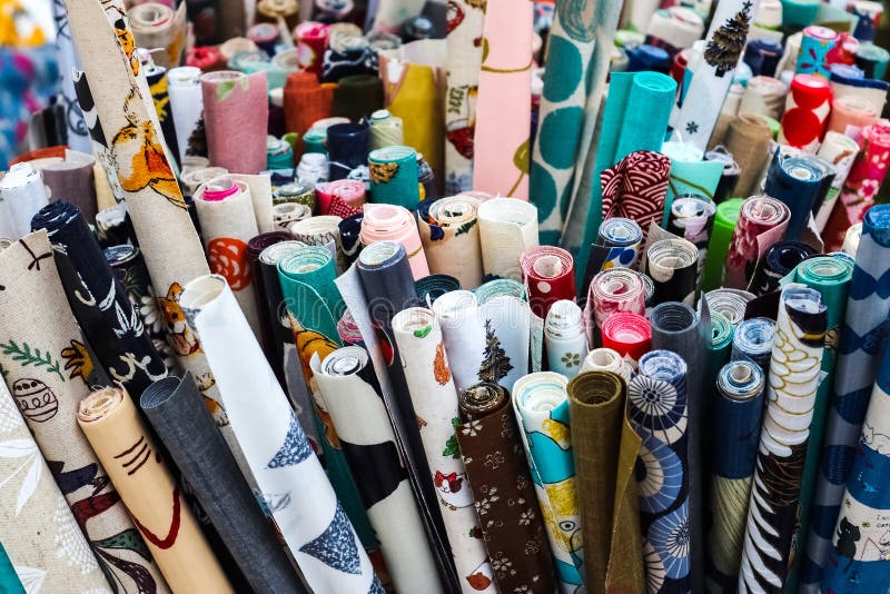 Kiel, Germany - 16. October 2022: Samples of cloth and fabrics with price signs in different colors found at a fabrics market. Kiel, Germany - 16. October 2022: Samples of cloth and fabrics with price signs in different colors found at a fabrics market.