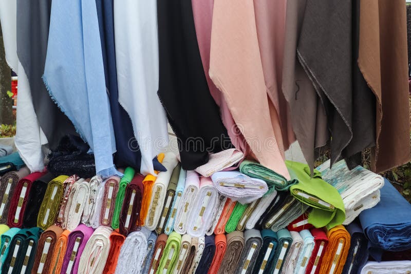 Kiel, Germany - 16. October 2022: Samples of cloth and fabrics with price signs in different colors found at a fabrics market. Kiel, Germany - 16. October 2022: Samples of cloth and fabrics with price signs in different colors found at a fabrics market.