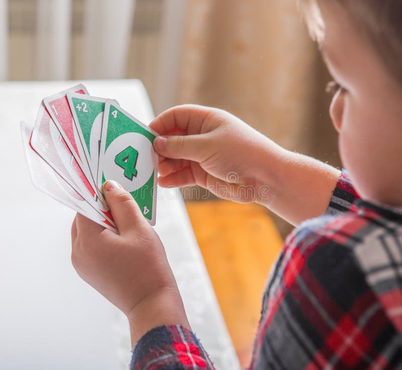 Uno cards in hand, card game Stock Photo by ©Egor_1896 239236398