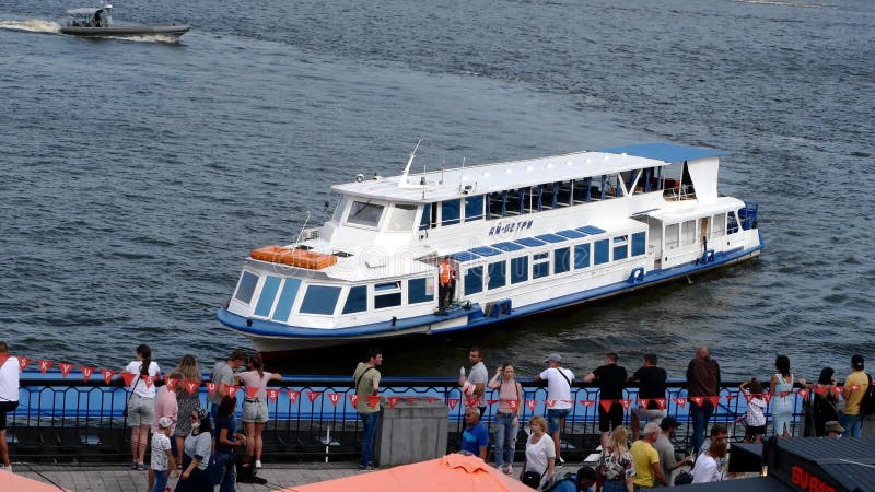 Kiev, Ukraine, July 2021: - Pleasure boat moored in port on weekend for an excursion along river or sea. Walking