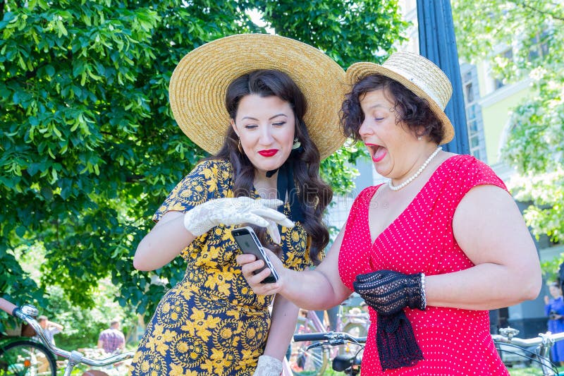 Kiev, Ukraine - May 12, 2018: Girls in vintage dresses on a retro bike stock photography Kiev, Ukraine - May 12, 2018: Girls in vintage dresses on a retro bike stock photography