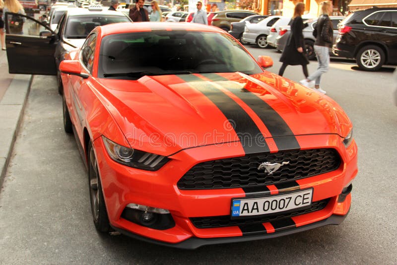 Kiev, Ukraine - May 3, 2019: Orange Ford Mustang in the city royalty free stock photography Kiev, Ukraine - May 3, 2019: Orange Ford Mustang in the city royalty free stock photography