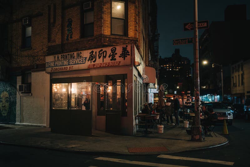 Kikis vintage signs at night, in the Lower East Side, Manhattan, New York