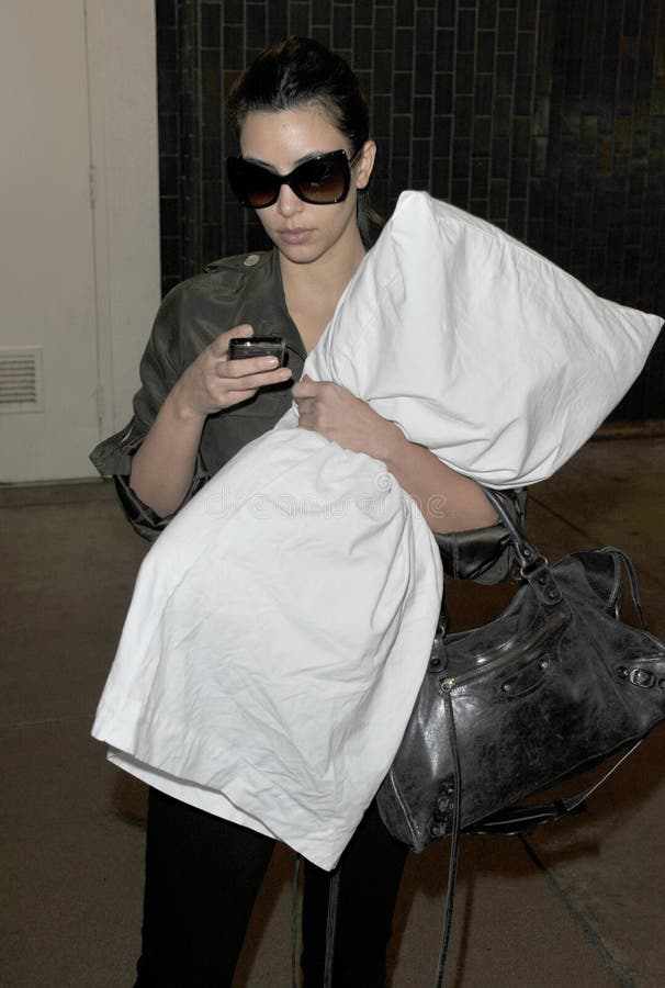 Kim Kardashian is seen hugging her pillow at LAX royalty free stock photography