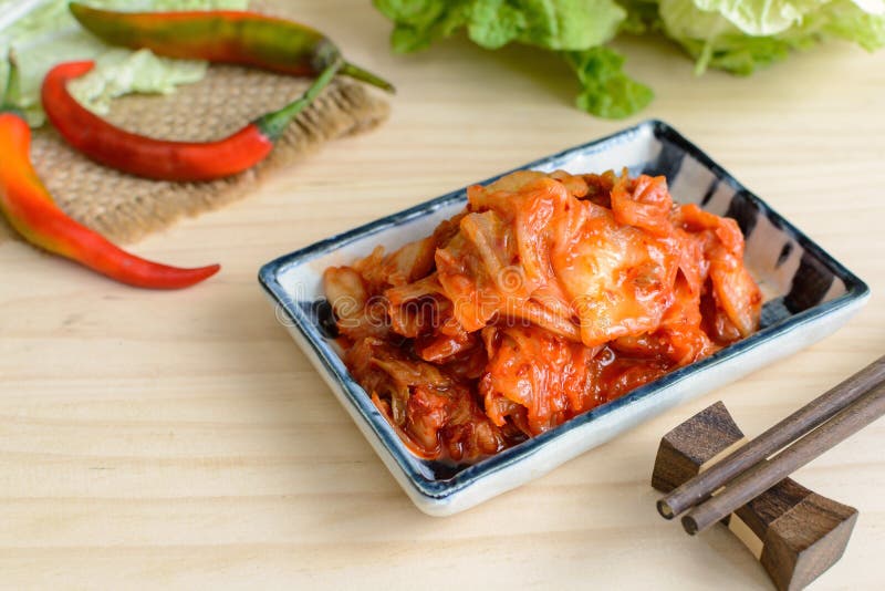 Kimchi with Chopsticks on wooden table, korean food