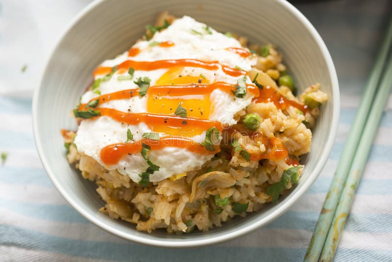 Kimchi Fried Rice with Fried Egg and Sriracha Stock Image - Image of