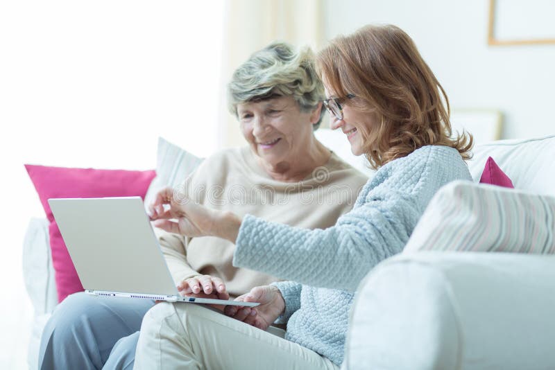 Kind carer teaching old lady