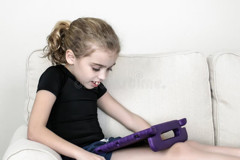 A girl with autism is wearing a short-sleeved compression shirt to assist with upper extremity stability / function and sensory processing disorder; wearing the garment allows her to focus on tasks. A girl with autism is wearing a short-sleeved compression shirt to assist with upper extremity stability / function and sensory processing disorder; wearing the garment allows her to focus on tasks