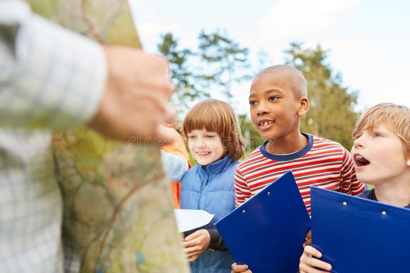 Children as detectives and explorers on a treasure hunt or scavenger hunt with clipboard. Children as detectives and explorers on a treasure hunt or scavenger hunt with clipboard