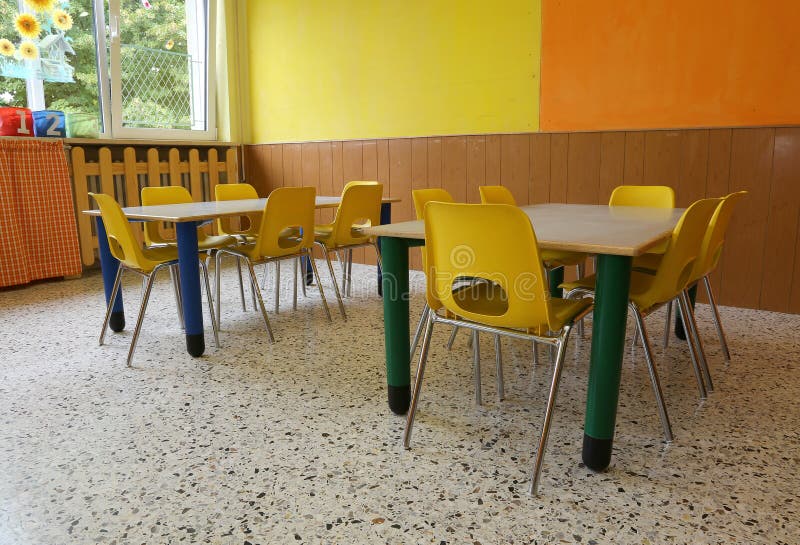 Kindergarten Classroom with Desks and Yellow Chairs without Kids Stock