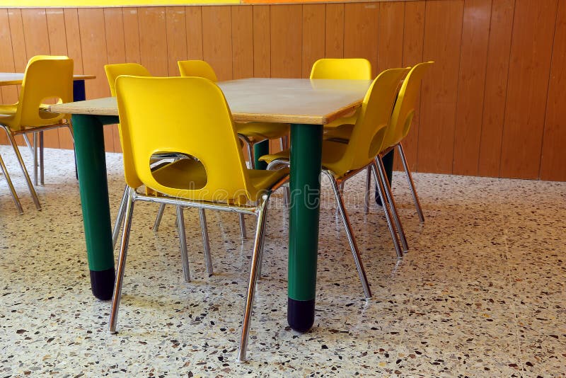 Kindergarten with Desks and Yellow Chairs without Kids Stock Photo
