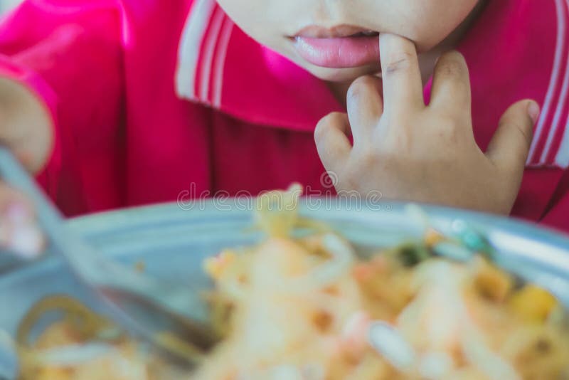 Kindergarten student is eating Pad Thai