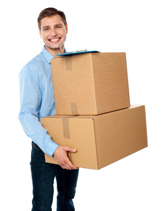 Full length side view of childish man sitting inside a cardboard box  pretending to drive a new car isolated over white background. Joyful guy  dreaming of buying a personal vehicle. Stock Photo