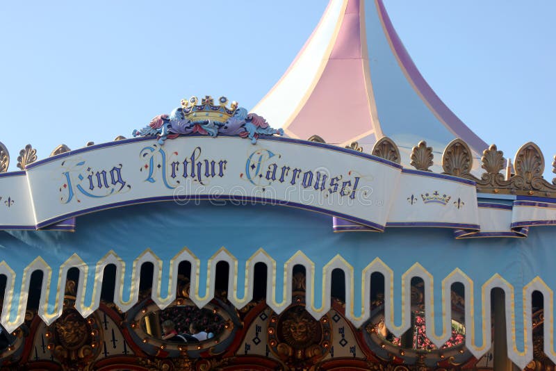 King Arthur Carrousel, Disneyland, Anaheim, California, with white painted galloping horses, each having its own name, with music in the background