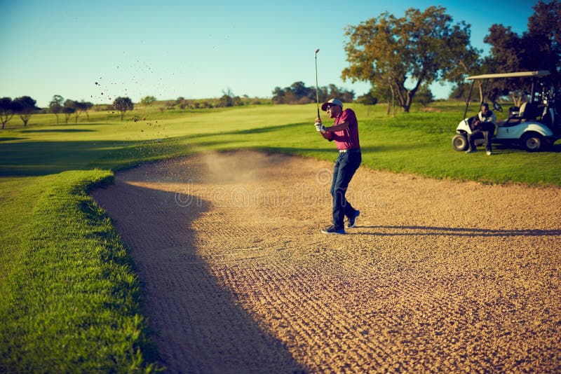 King of the Swing. a Golfer Chipping His Ball Out of a Bunker. Stock