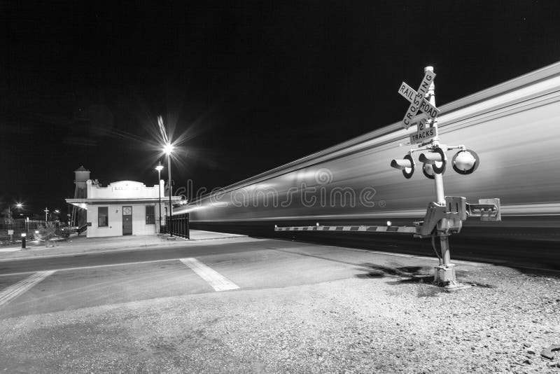 train passes at railroad crossing Kingman in the night