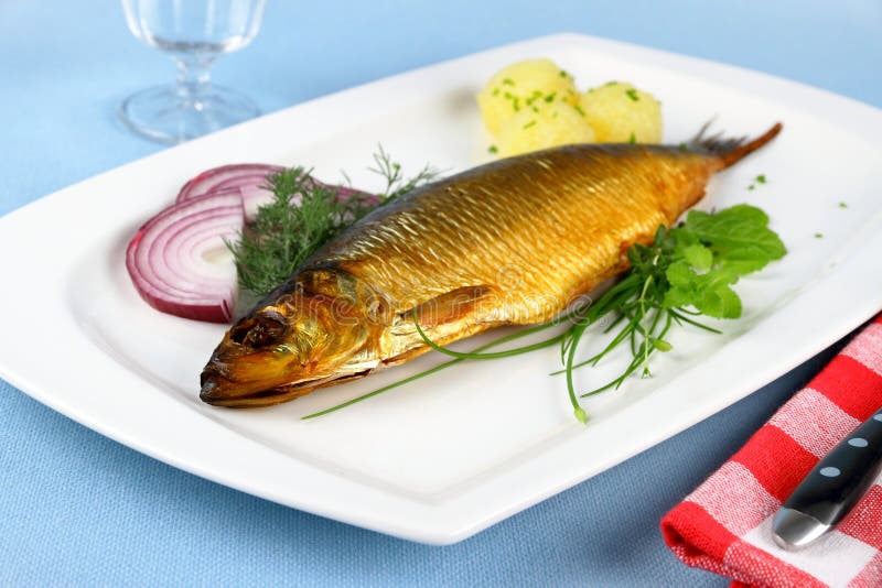 Kippers, Smoked Herring on a White Plate with Garnish Stock Image