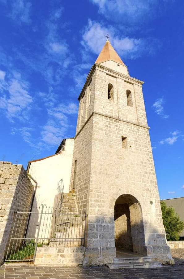 The pyramidal tower of the Church of our Lady of Health, a romanesque cathedral formely named St Michael the archangel, basilica at the Square of the The Glagolitic housed monasteries on Krk island, in Croatia. The pyramidal tower of the Church of our Lady of Health, a romanesque cathedral formely named St Michael the archangel, basilica at the Square of the The Glagolitic housed monasteries on Krk island, in Croatia.