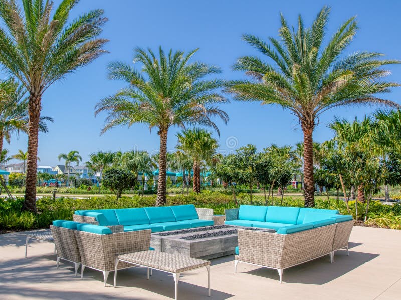 KISSIMMEE, FLORIDA - MAY 29, 2019 - Margaritaville Resort Orlando. Aqua couches under palm trees mark a lounge area for outside royalty free stock image KISSIMMEE, FLORIDA - MAY 29, 2019 - Margaritaville Resort Orlando. Aqua couches under palm trees mark a lounge area for outside royalty free stock image