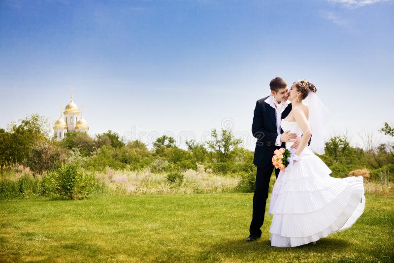 Kissing the bride in the park