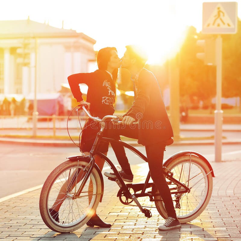 Kissing romantic couple in love. Sunset. Boy and girl standing n