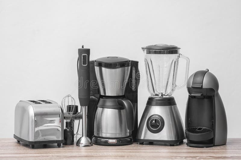 Kitchen Appliances on Table Against Light Background Stock Photo
