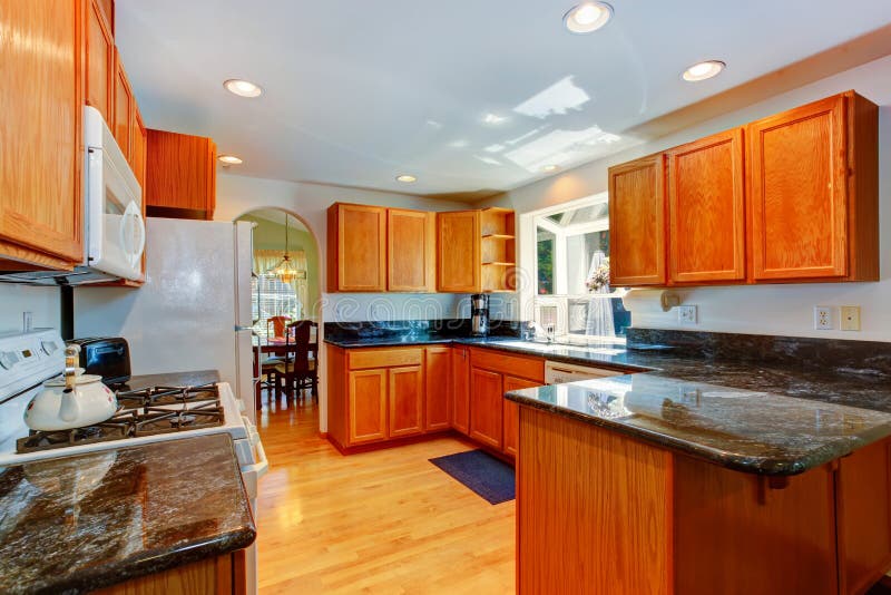 Kitchen cabinets with black granite tops