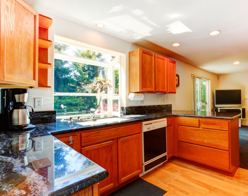 Kitchen cabinets with black granite tops