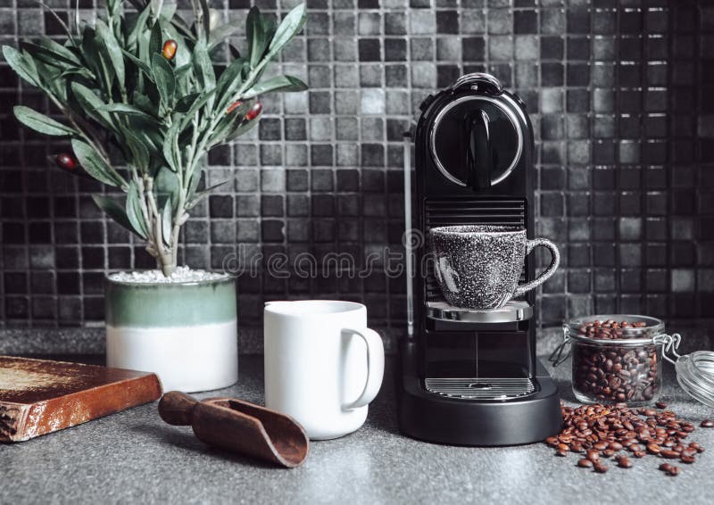 Kitchen with coffee machine,raw beans with scoop and white cup for perfect morning breakfast on black