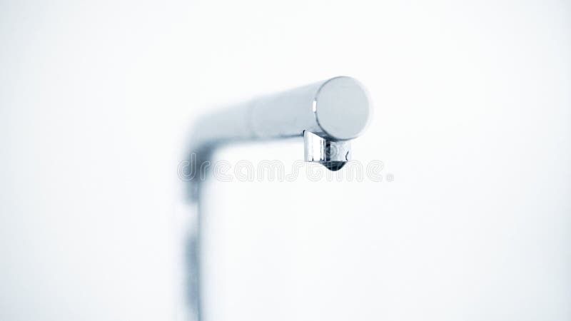 Kitchen faucet with dripping water drops.