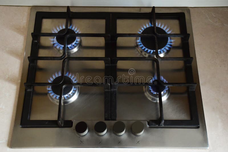 Kitchen Gas Stove with Four Burners Burning Blue Flame Stock Image