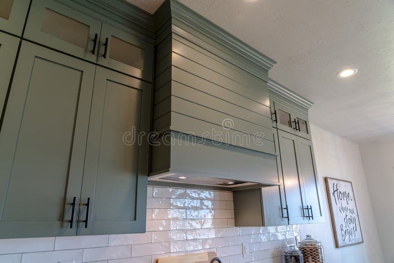 Kitchen Interior With Hanging Cabinets Against Tile Backsplash And