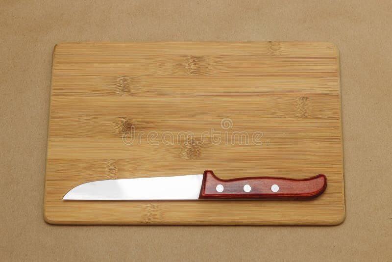 Kitchen Knife and Cutting Board on the Table with Copyspace. Stock
