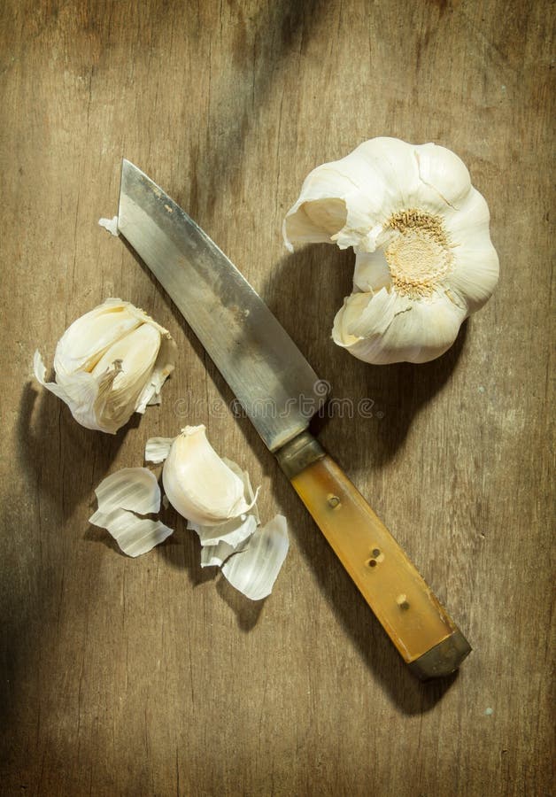 Kitchen knife with garlic stock image. Image of natural 34847533
