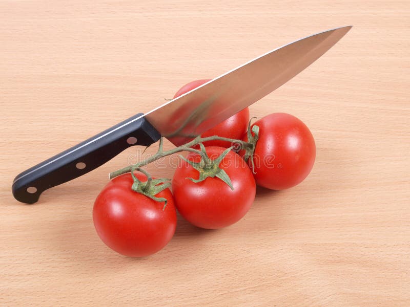Knife and tomato three stock photo. Image of produce 135123120