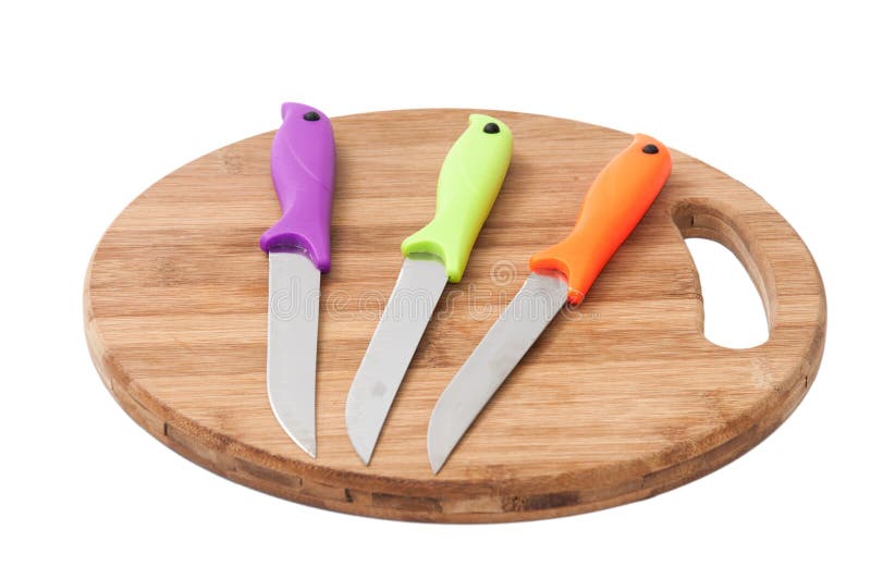 Kitchen Knives with Colorful Plastic Handles on a Wooden Board Stock