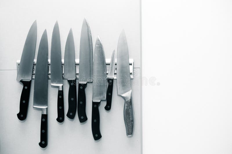 Kitchen Knives Set on a on a Light Wall for Background. T Stock