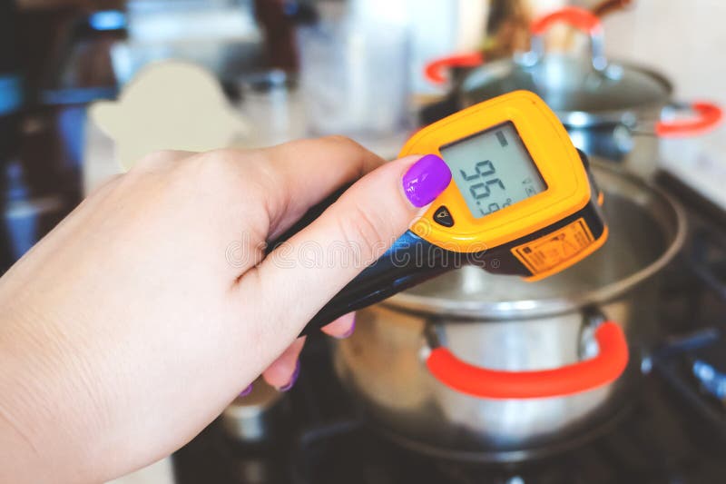 Measuring the temperature of chocolate in a bowl. Special infrared