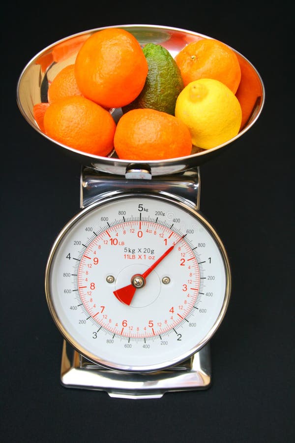 Fruit on weighing scales. stock photo. Image of face 12399550