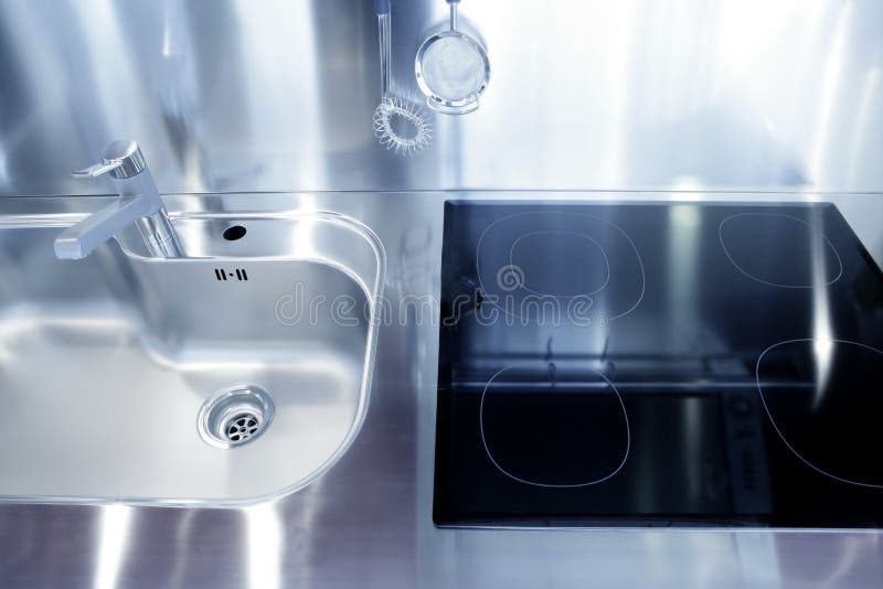 Kitchen silver sink and vitroceramic stove hob royalty free stock images