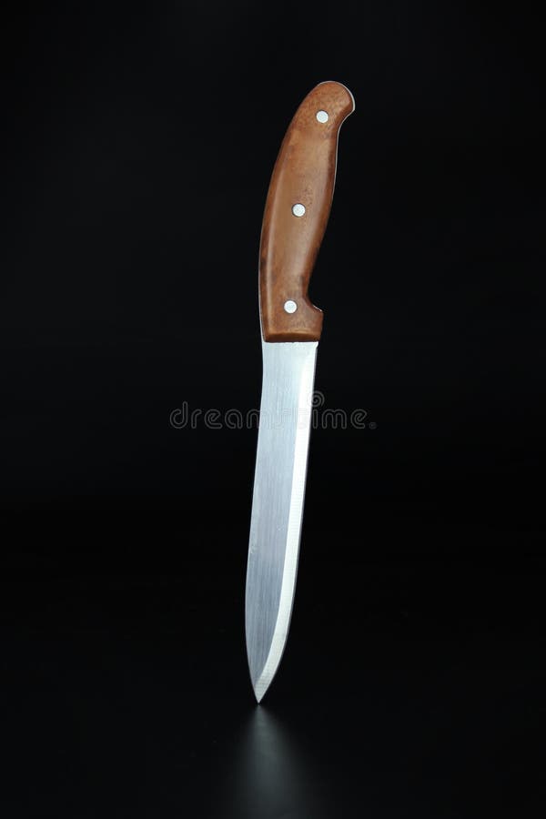 Kitchen Slicing Knife on Concrete. Kitchen Knife Balanced on Its End