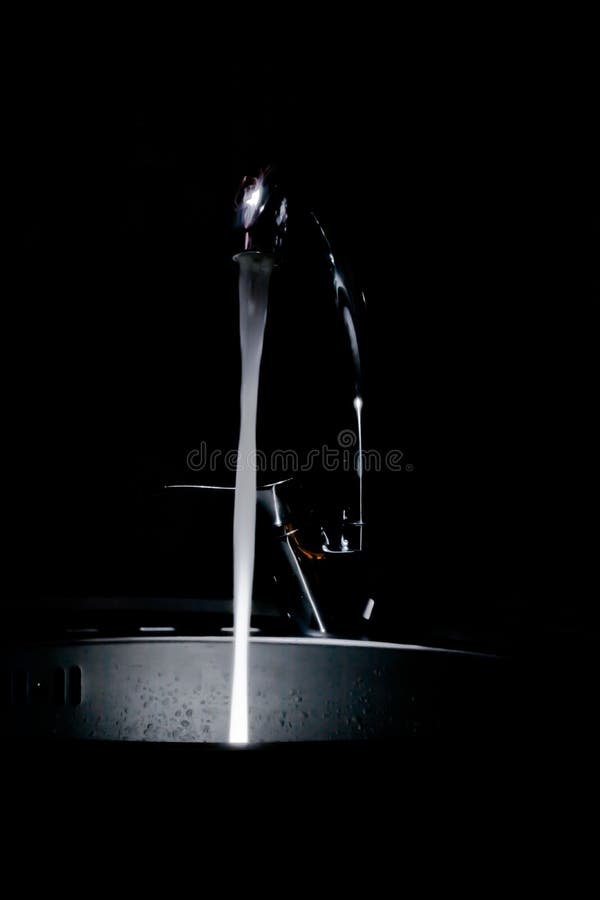The kitchen tap water flowing glowing royalty free stock photo The kitchen tap water flowing glowing royalty free stock photo